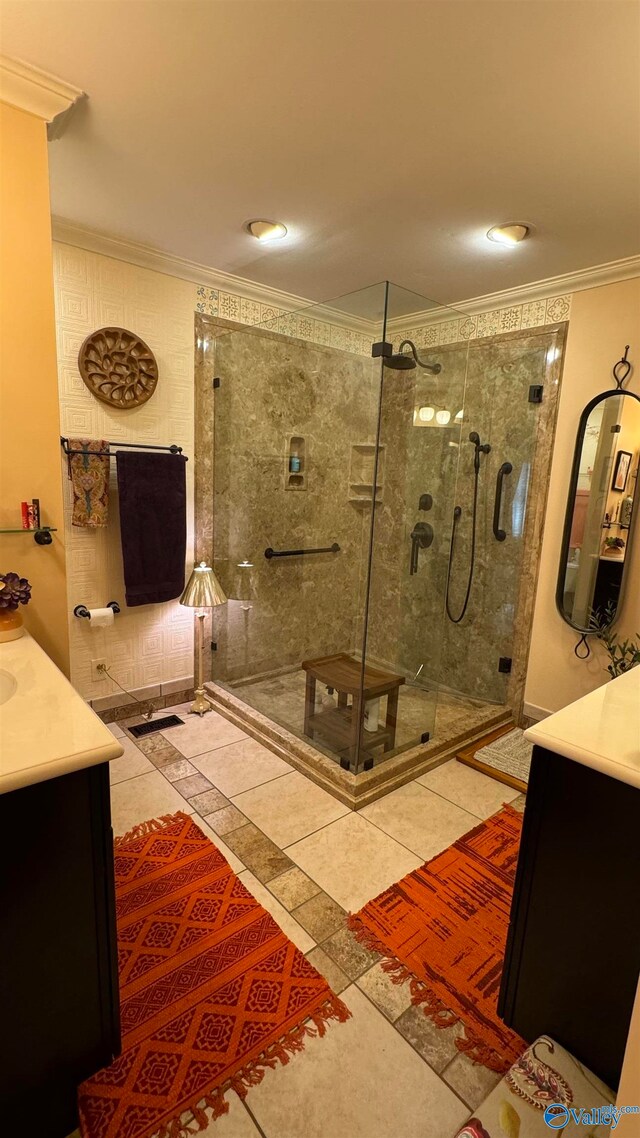 bathroom with vanity, tile patterned floors, a shower with door, and ornamental molding