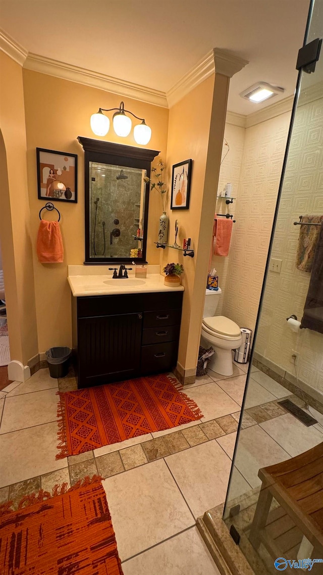 bathroom with toilet, tile patterned floors, walk in shower, ornamental molding, and vanity