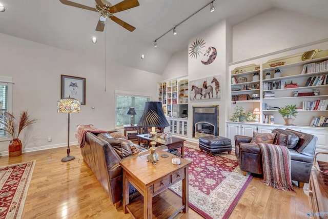 living room featuring ceiling fan, high vaulted ceiling, track lighting, and light hardwood / wood-style flooring