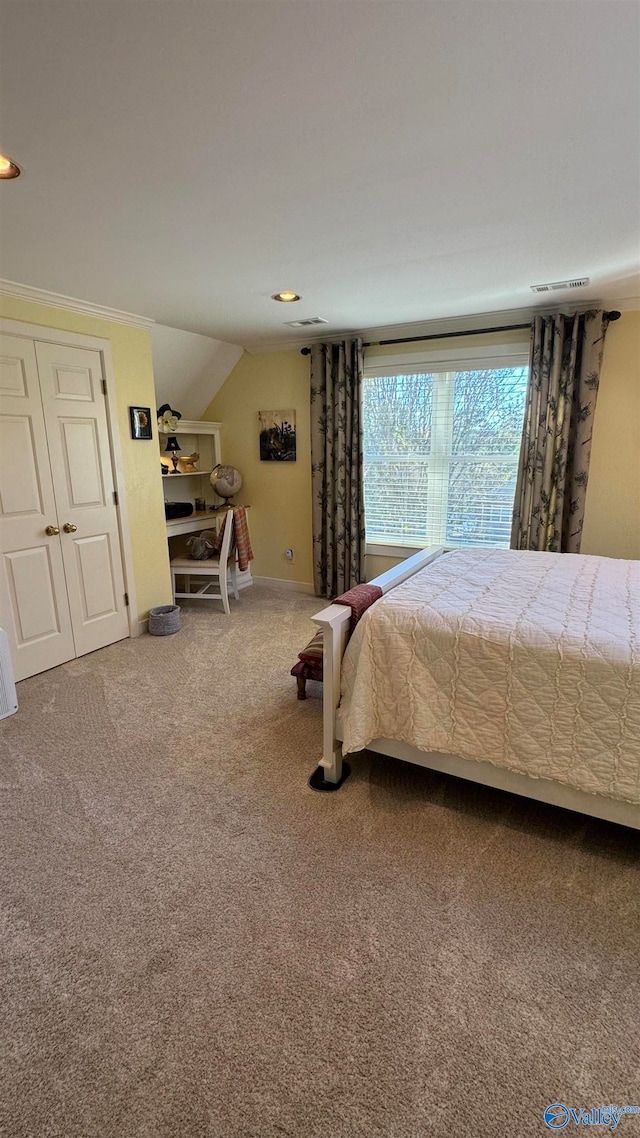 bedroom with carpet floors and vaulted ceiling