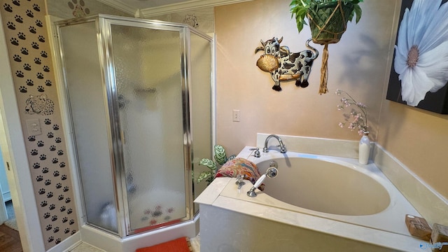 bathroom featuring ornamental molding and shower with separate bathtub