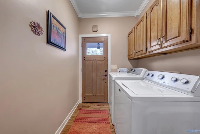 laundry room with washer and clothes dryer, light hardwood / wood-style floors, ornamental molding, and cabinets