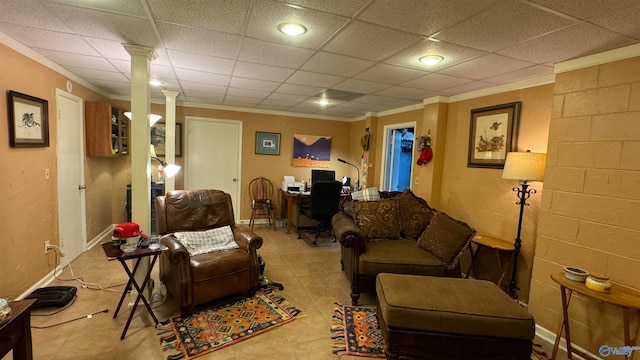 tiled living room with a drop ceiling and ornamental molding