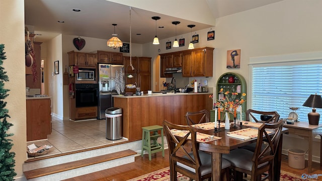 dining area featuring light hardwood / wood-style floors and vaulted ceiling