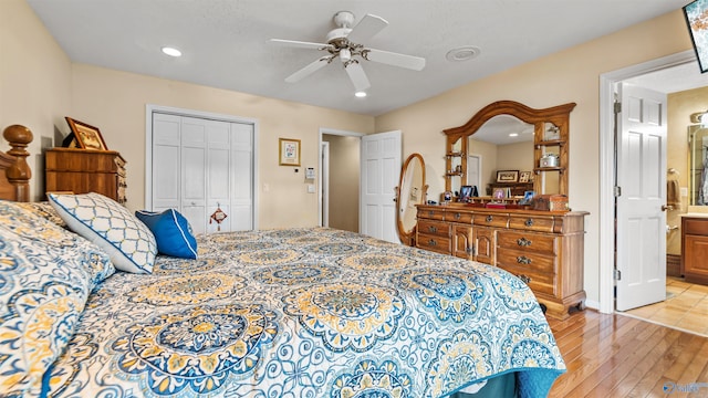 bedroom with ceiling fan, a closet, light wood-type flooring, and ensuite bath