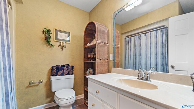 bathroom with vanity, toilet, and tile patterned floors