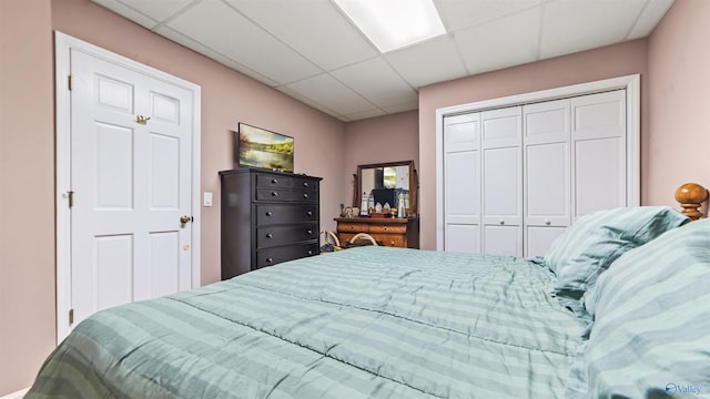 bedroom with a closet and a drop ceiling