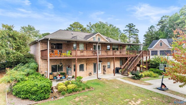 back of property featuring a lawn, a patio, and a deck