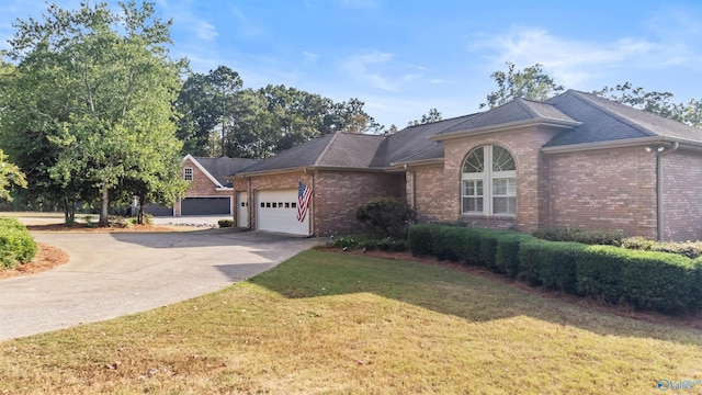 single story home featuring a garage and a front yard