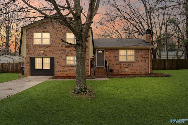 tri-level home featuring a lawn