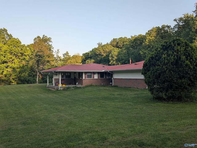 1350 W US Highway 278 W, Cullman, AL 35057 - back of property featuring brick siding, a lawn, and metal roof