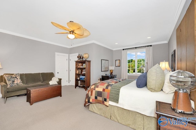 carpeted bedroom featuring ceiling fan and crown molding