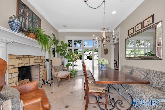 tiled dining area with ornamental molding, a healthy amount of sunlight, a notable chandelier, and a fireplace