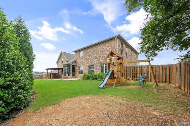 4513 Stone Park Cir, Owens Cross Roads, AL 35763 - back of house with brick siding, a playground, and a fenced backyard