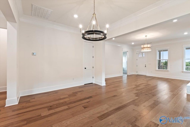 interior space featuring crown molding, hardwood / wood-style floors, and a notable chandelier