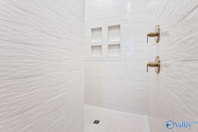 bathroom with a tile shower