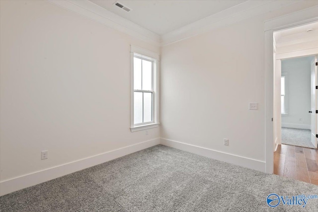 unfurnished room featuring ornamental molding and carpet