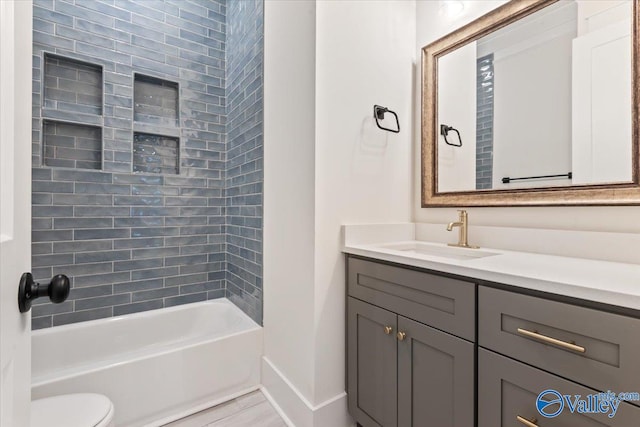 full bathroom with vanity, toilet, and tiled shower / bath