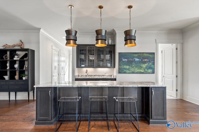 bar with pendant lighting, dark hardwood / wood-style flooring, crown molding, and light stone countertops