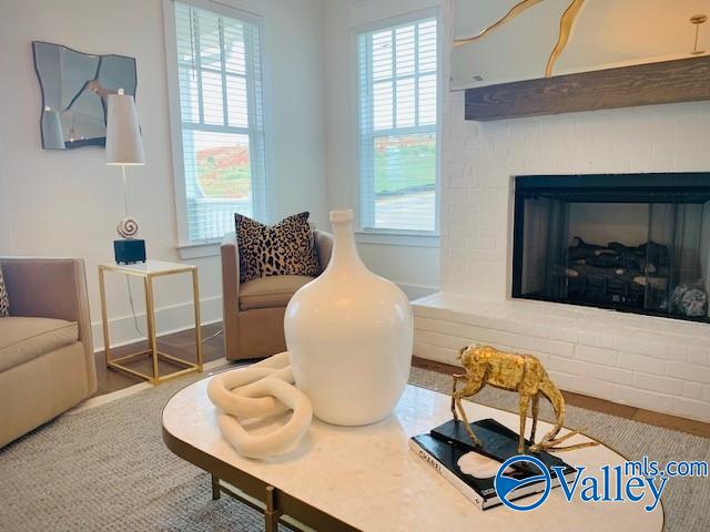 sitting room featuring a brick fireplace