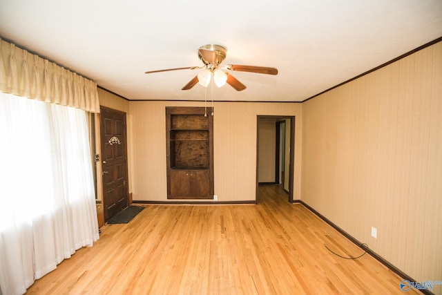 unfurnished bedroom with crown molding, ceiling fan, and light hardwood / wood-style floors