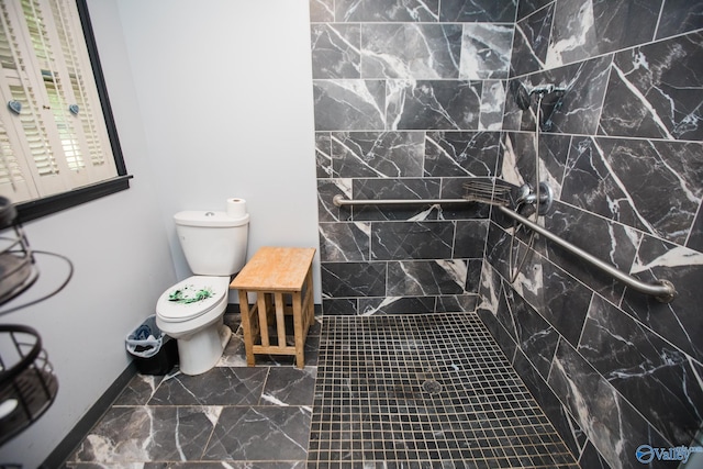 bathroom featuring toilet and tiled shower