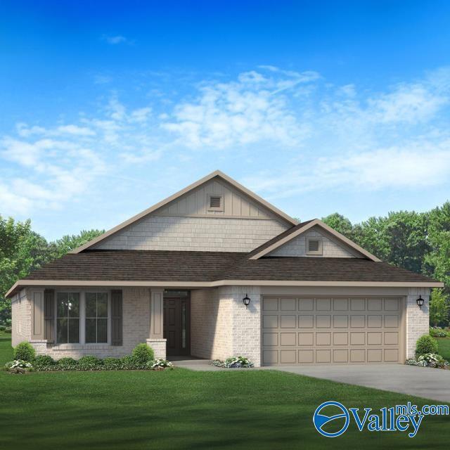 view of front of home with a front yard and a garage