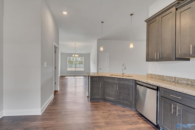 kitchen with dishwasher, sink, light stone counters, dark hardwood / wood-style floors, and pendant lighting