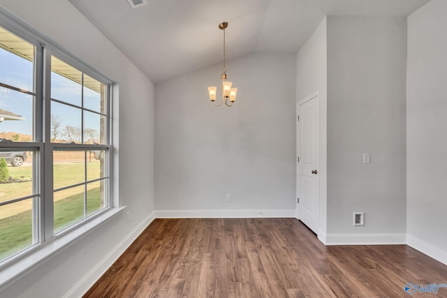 empty room with an inviting chandelier, vaulted ceiling, and dark wood-type flooring