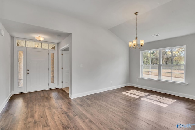 foyer featuring lofted ceiling, a chandelier, and dark hardwood / wood-style floors