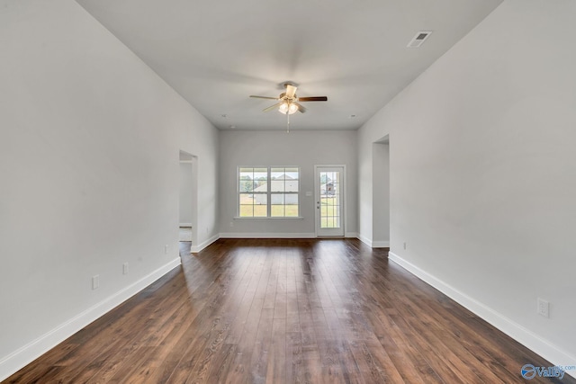 empty room with ceiling fan and dark hardwood / wood-style floors