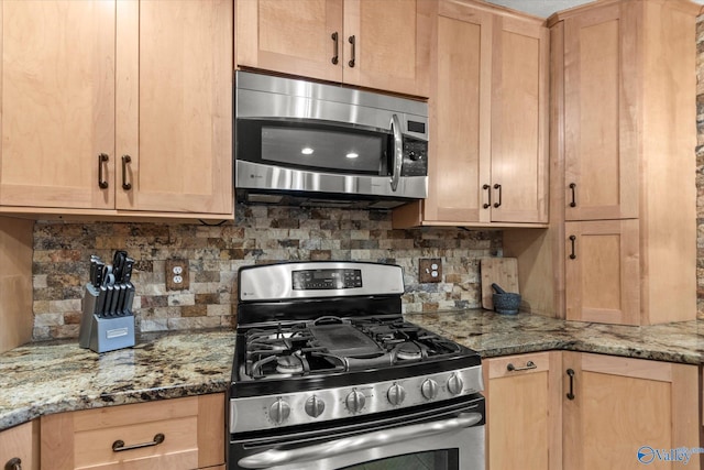 kitchen with appliances with stainless steel finishes, light brown cabinets, tasteful backsplash, and light stone counters