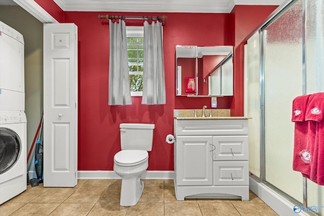 bathroom featuring tile patterned floors, crown molding, vanity, and stacked washer / drying machine
