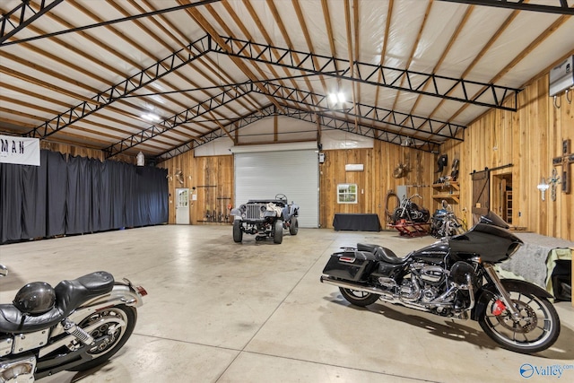 garage featuring a carport and wood walls