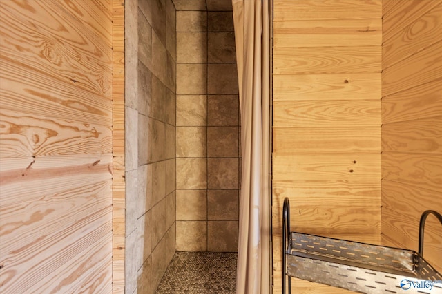 bathroom featuring wooden walls