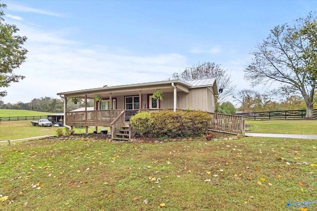 view of front of property featuring a porch, a rural view, and a front yard