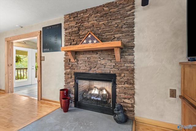 interior details with a fireplace, concrete floors, and a textured ceiling