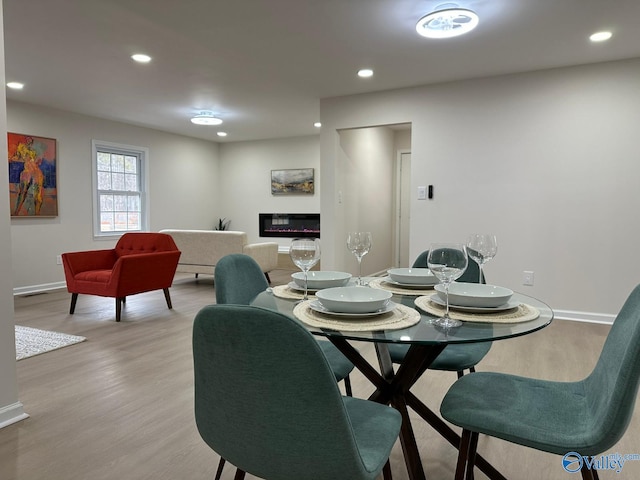 dining space with light wood-type flooring