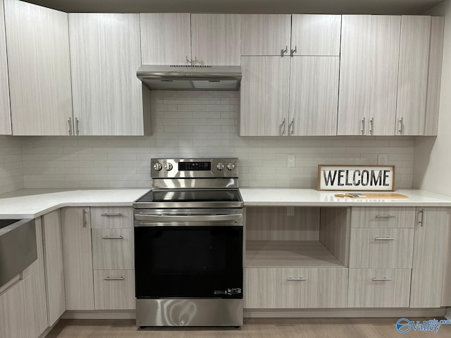 kitchen featuring tasteful backsplash, light brown cabinetry, and electric stove