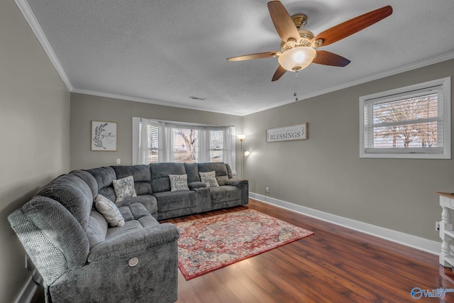 living room featuring a textured ceiling, ceiling fan, dark hardwood / wood-style floors, and ornamental molding