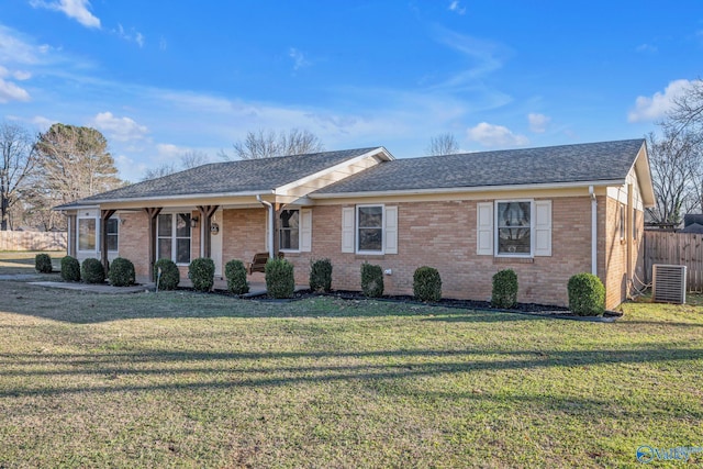 ranch-style house featuring a front yard and central AC