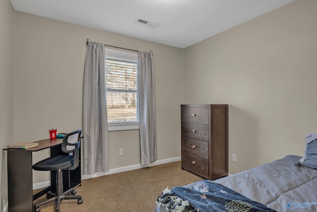 carpeted bedroom featuring a textured ceiling