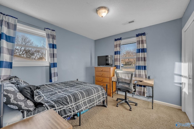 bedroom featuring carpet and a textured ceiling