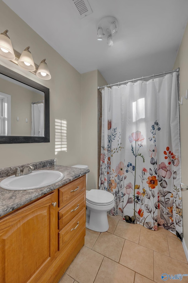 bathroom featuring tile patterned floors, vanity, and toilet