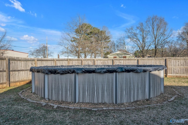 view of swimming pool with a yard