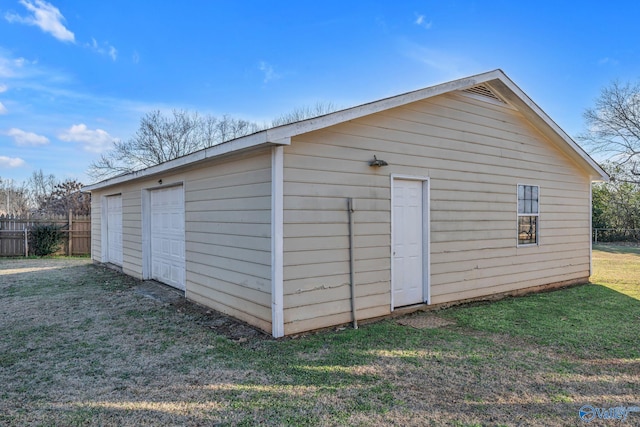 view of outbuilding with a yard and a garage