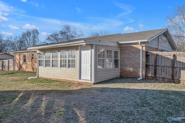 back of property featuring a lawn