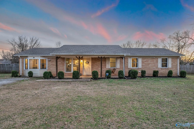 ranch-style home with a lawn