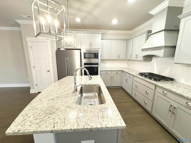 kitchen featuring stainless steel appliances, a sink, custom exhaust hood, decorative backsplash, and crown molding