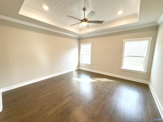 empty room featuring a tray ceiling, dark wood-style flooring, wooden ceiling, and baseboards